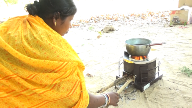Lady with cookstove | The Core Carbon Project will distribute improved energy efficiency cookstoves to families in rural villages in India. Read more about this innovative project.